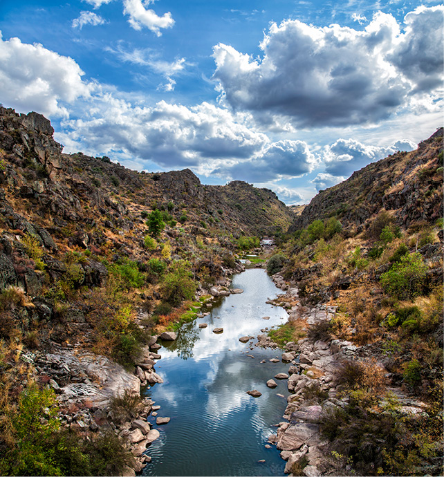 Nature park surrounded by a river and mountains 