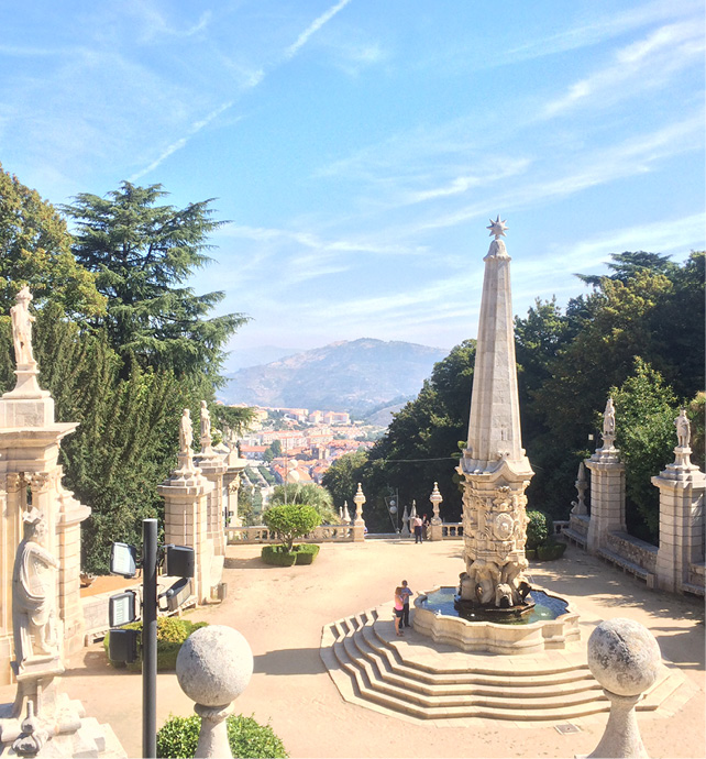 a large stone fountain with a fountain in the middle of a park