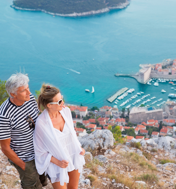 Couple looking over Dubrovnik harbour and old town in Croatia