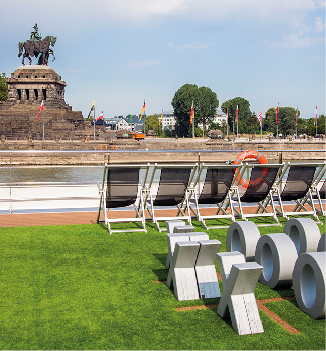 Sun Deck loungers and noughts and crosses game, with Deutsches Eck in the background, Koblenz, Germany on the Rhine River 