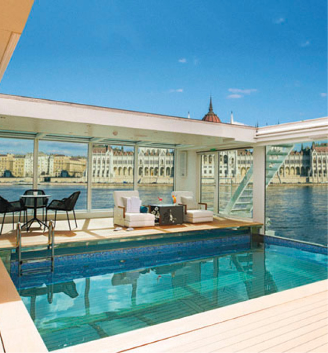 Star-Ship indoor pool and poolside seating, with Hungarian Parliament Building, Budapest, Hungary in the background