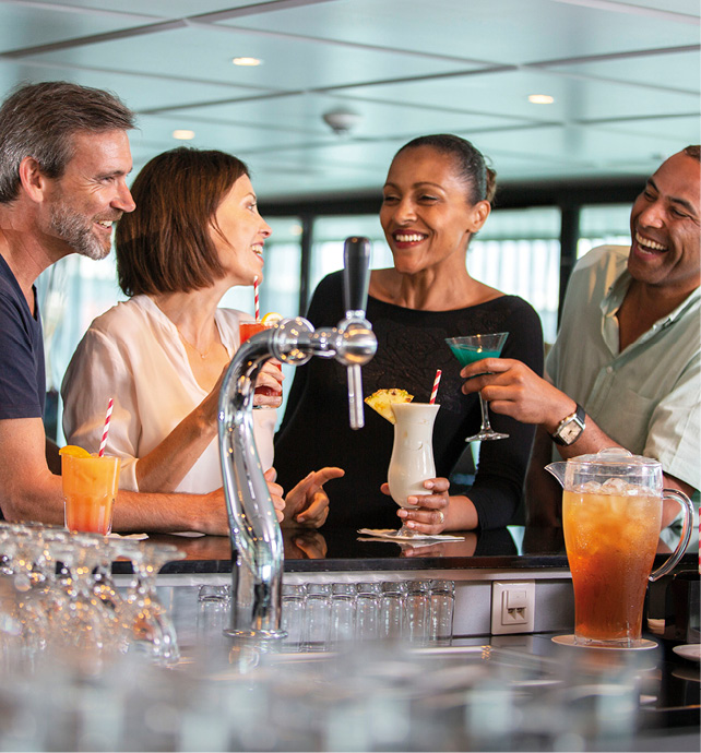 Friends enjoying a tipple together in the bar on board a luxury river ship 