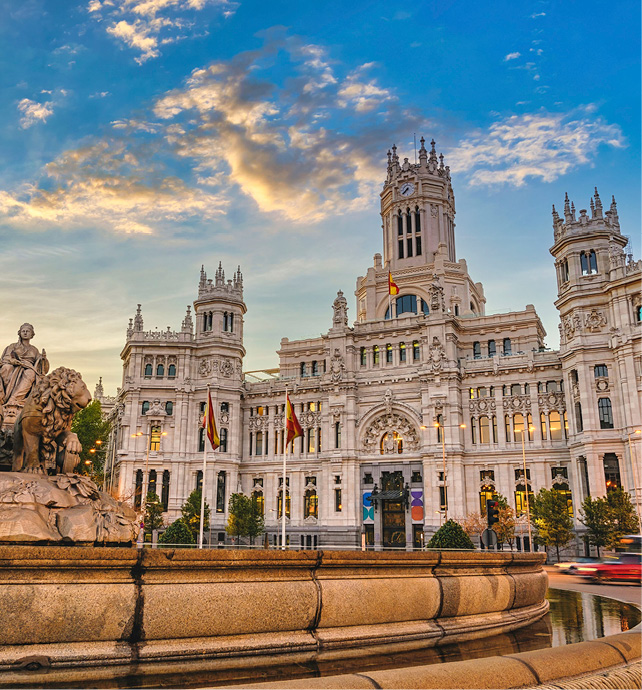 Sun rising over Cibeles Fountain Town Square, Madrid, Spain